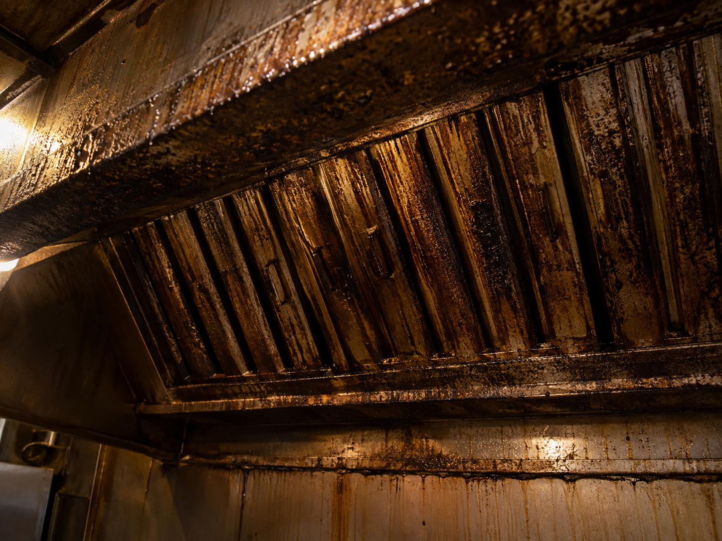Grease-coated hood baffle filters before cleaning